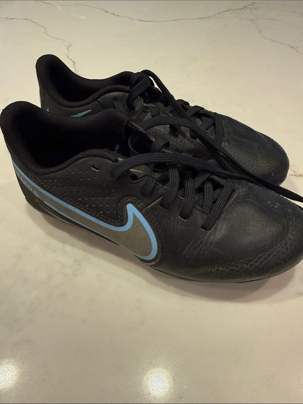 Nike Youth Black Athletic Cleats with Light Blue Swoosh